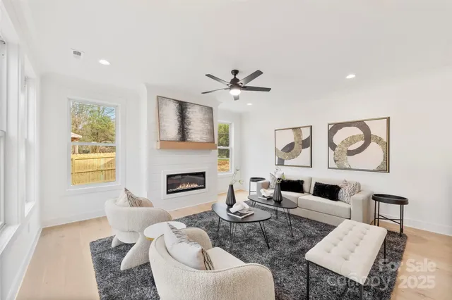 a living room with furniture a fireplace and a flat screen tv