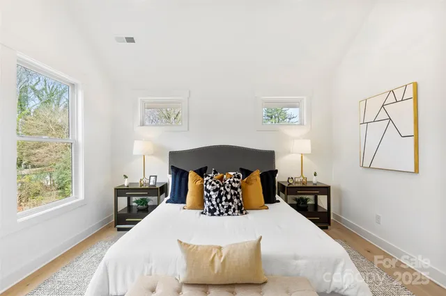 a bed room with a bed and a chandelier