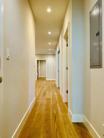 a view of hallway with wooden floor