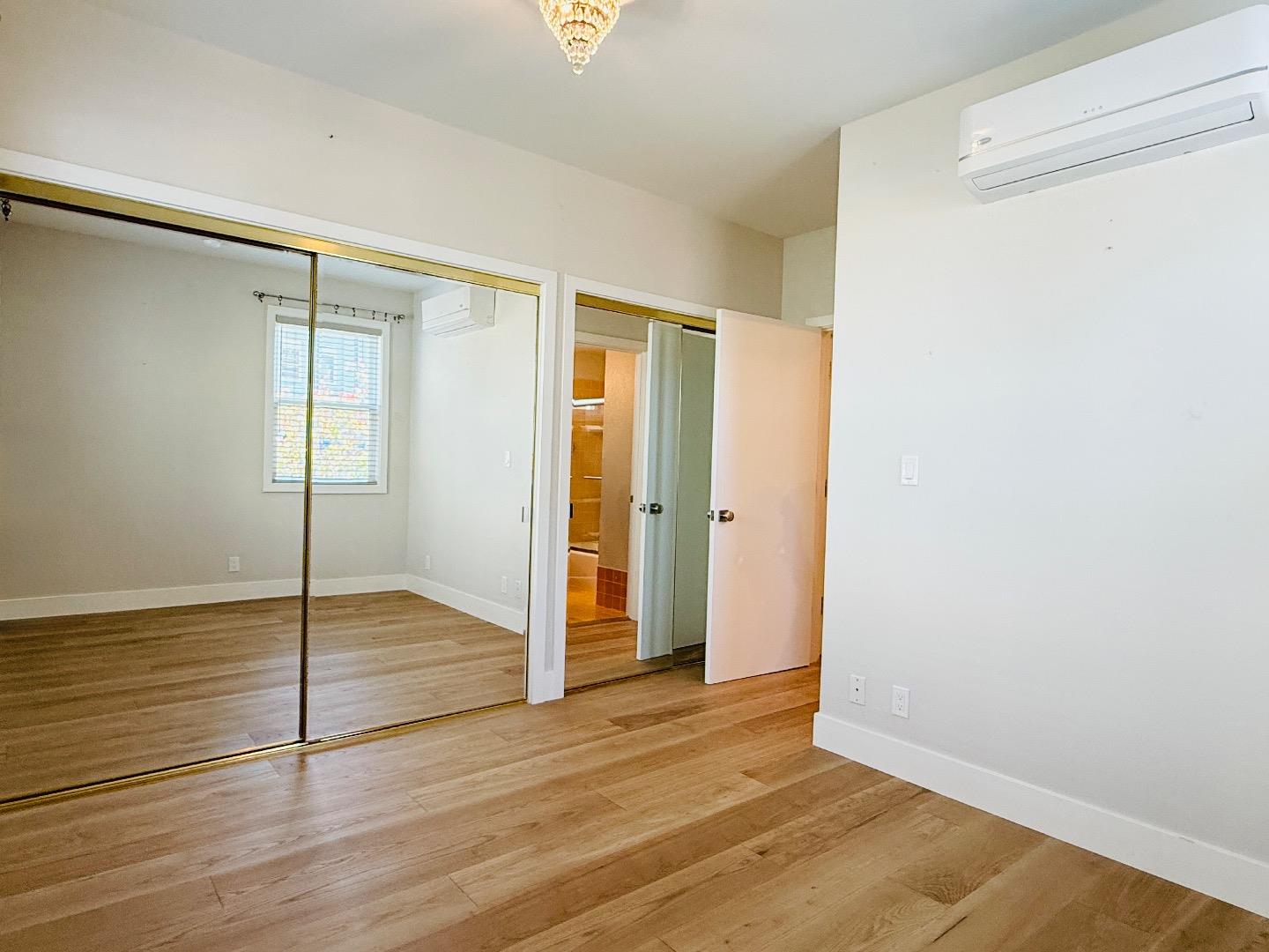 125 Park Road, Unit B Burlingame, CA 94010 - Photo 8 of 13 a view of an empty room with wooden floor and a window