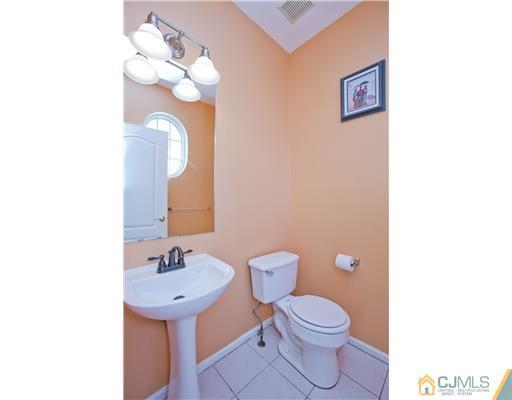 41 Timber Ridge Road North Brunswick, NJ 08902 - Photo 14 of 25 a bathroom with a toilet sink and mirror