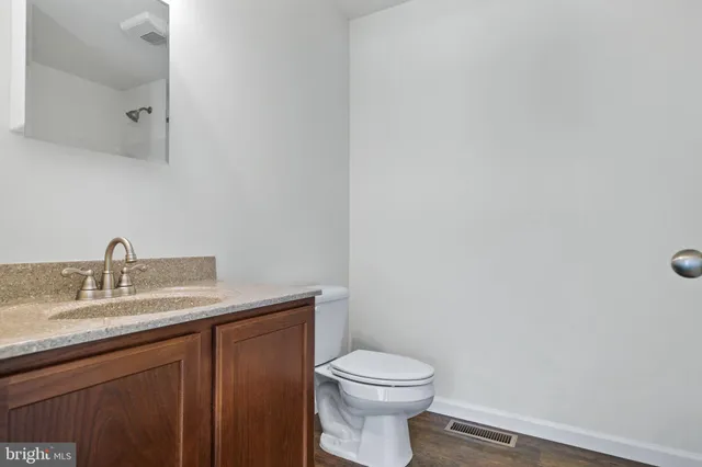 a white toilet sitting next to a bathroom sink