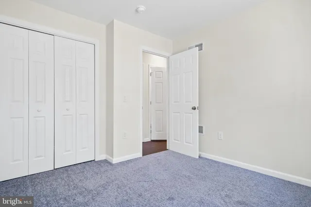 an empty room with closet area