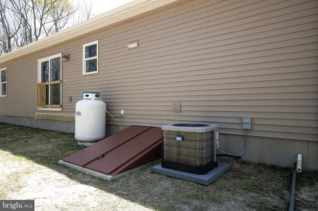 a view of a chairs in back yard of the house