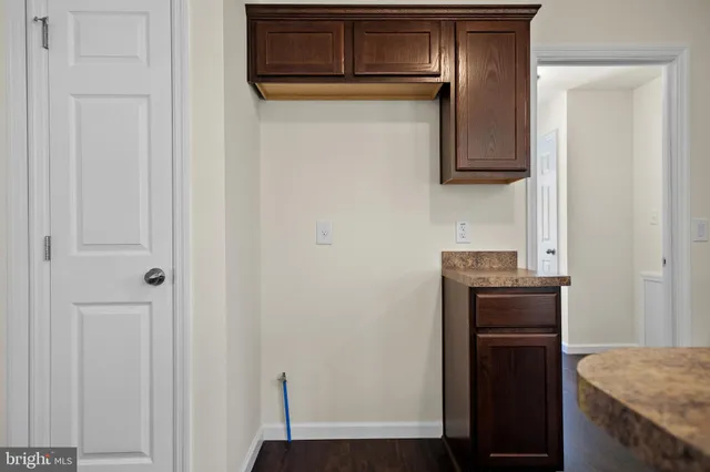 a kitchen with granite countertop white cabinets and stainless steel appliances