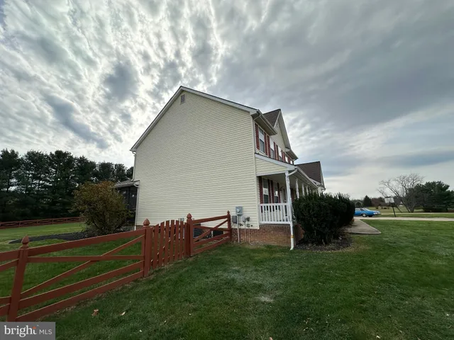a view of a house with wooden floor roof and wooden fence