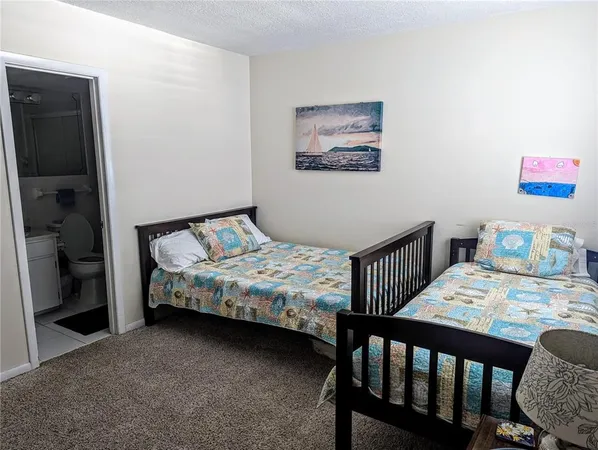 a bedroom with a bed a table and chair