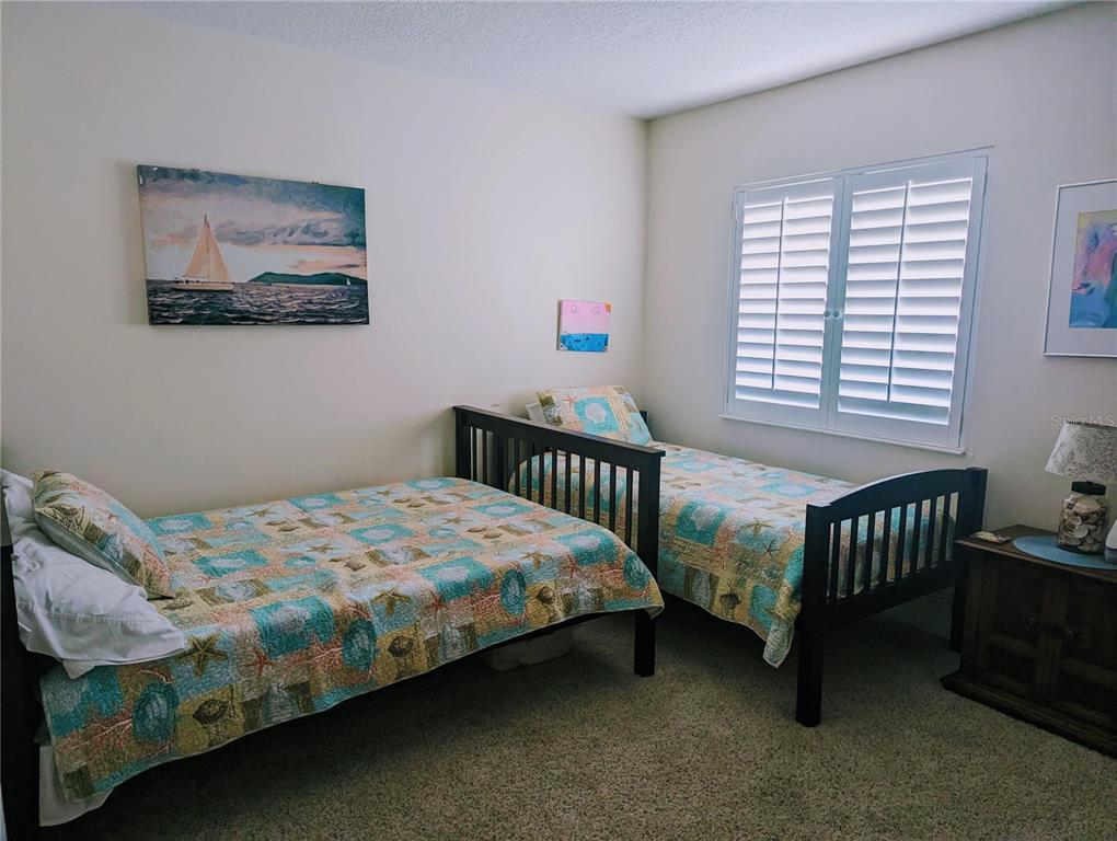 815 Ocean Shore Boulevard, Unit 11A Ormond Beach, FL 32176 - Photo 8 of 10 a bedroom with a bed and a window