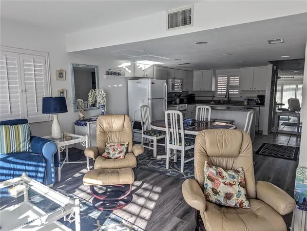 a living room with furniture and a dining table