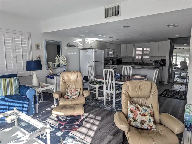 a living room with furniture and a dining table