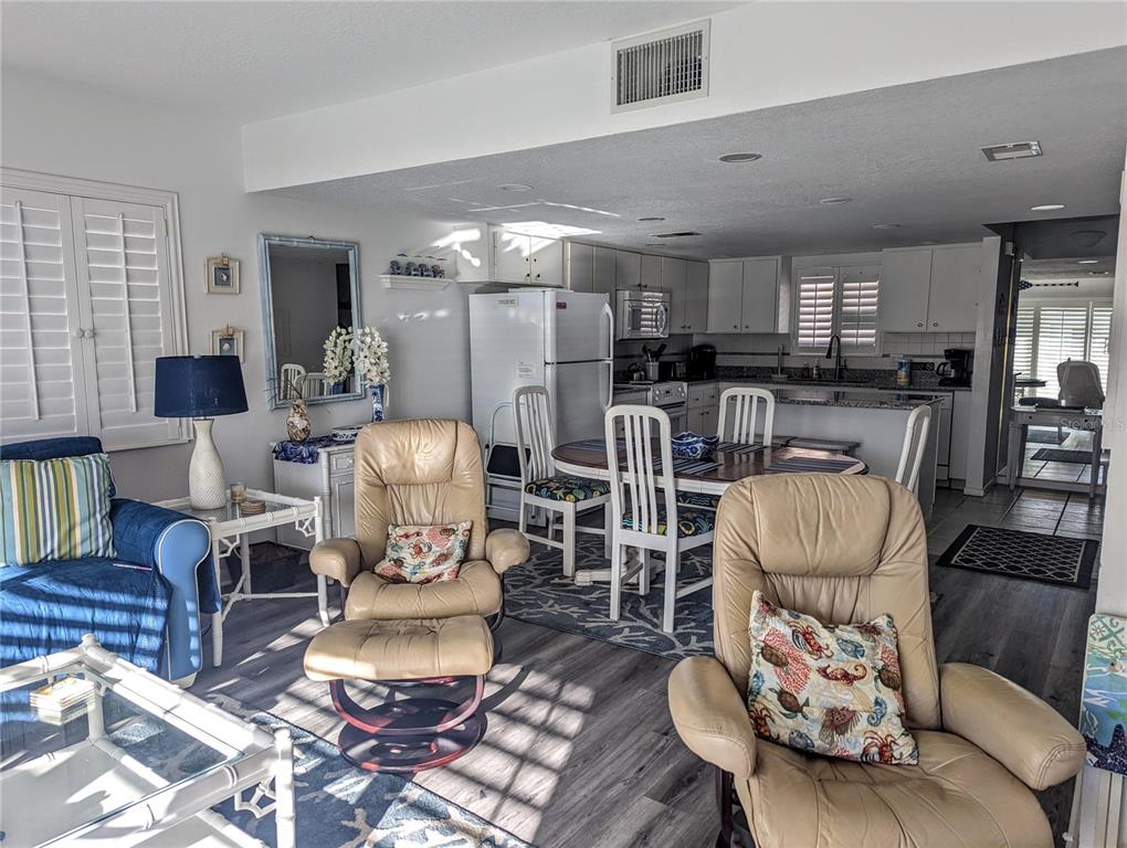 815 Ocean Shore Boulevard, Unit 11A Ormond Beach, FL 32176 - Photo 10 of 10 a living room with furniture and a dining table