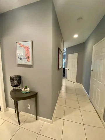 a view of a hallway with seating area