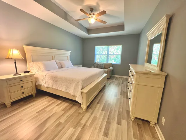 a bedroom with a bed and a chandelier