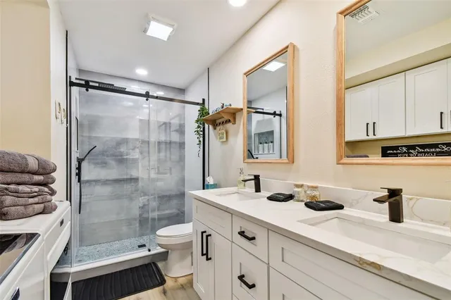 a bathroom with a glass shower door