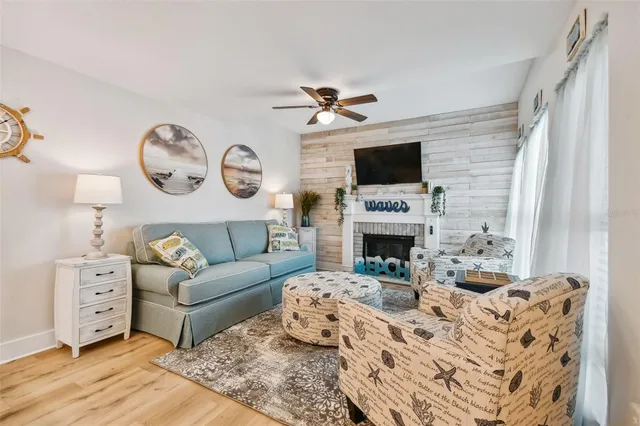 a living room with furniture a fireplace and a flat screen tv