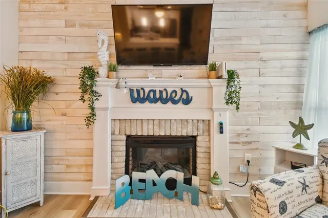 a living room with a fireplace and a flat screen tv