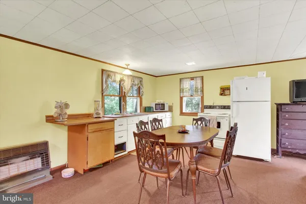 a dining room with furniture and window