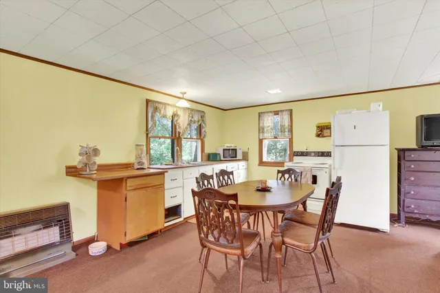 a dining room with furniture and window