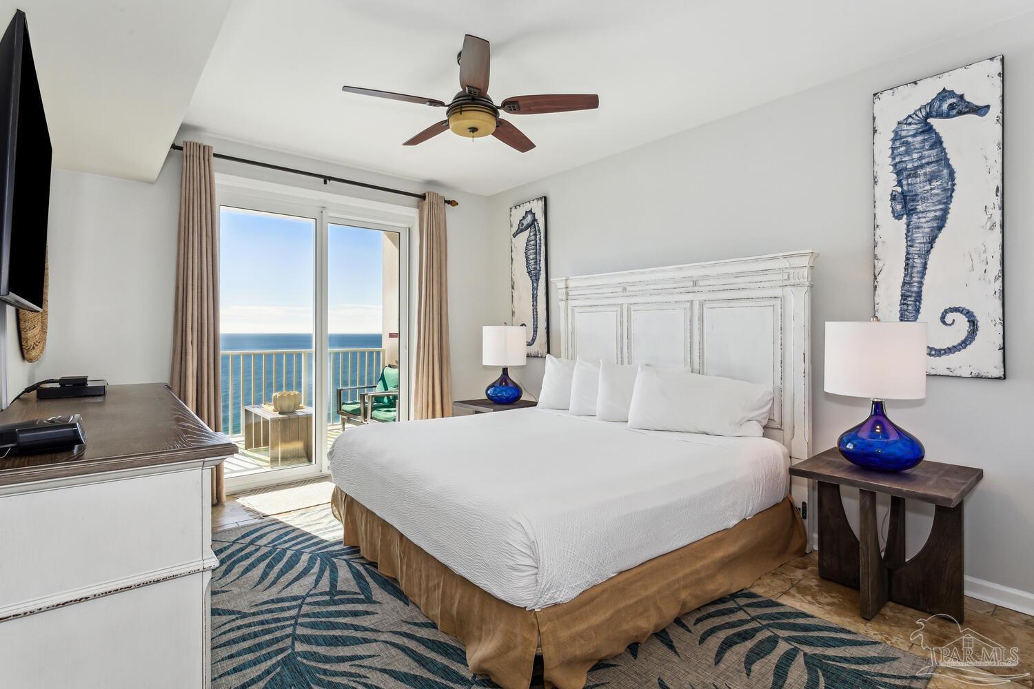 14511 Perdido Key Drive, Unit 1303 Perdido Key, FL 32507 - Photo 11 of 58 a bedroom with a bed and a chandelier