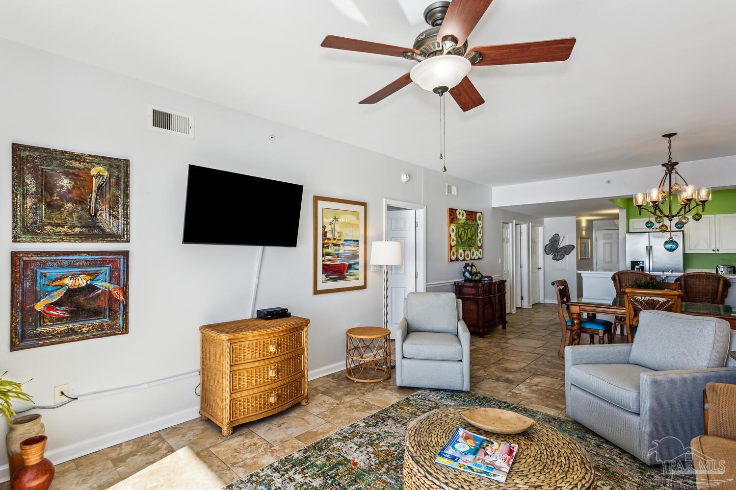 14511 Perdido Key Drive, Unit 1303 Perdido Key, FL 32507 - Photo 14 of 58 a living room with furniture a flat screen tv and a chandelier