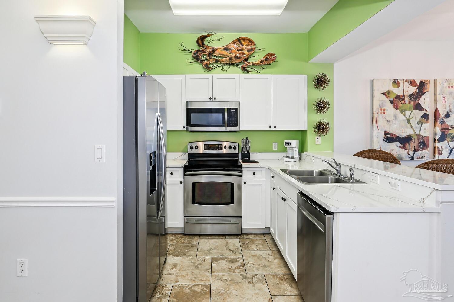 14511 Perdido Key Drive, Unit 1303 Perdido Key, FL 32507 - Photo 17 of 58 a kitchen with a stove and a microwave