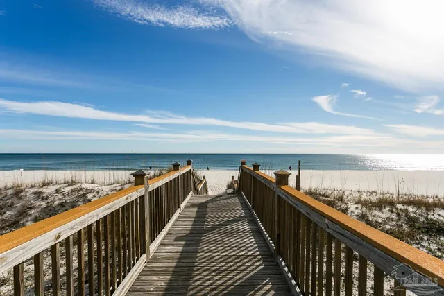 a view of a balcony with table and chairs and potted plants