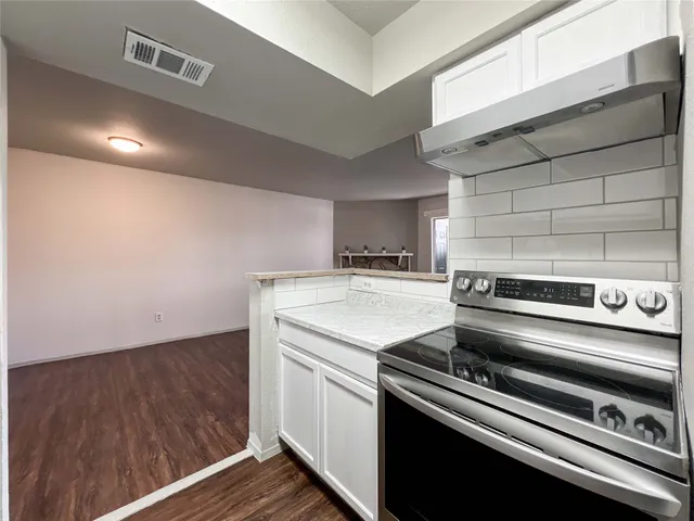 a kitchen with a stove and a microwave