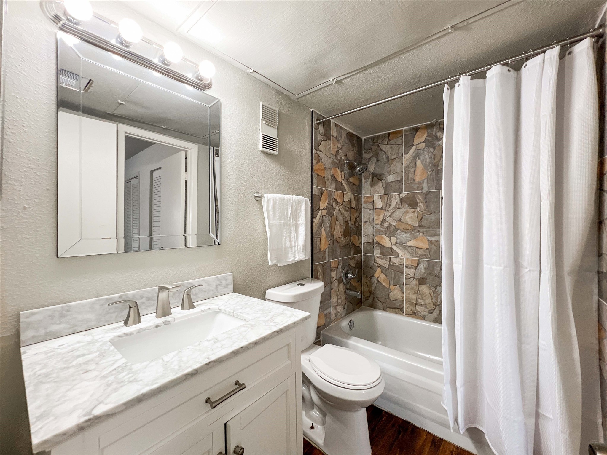 6001 Reims Road, Unit 1207 Houston, TX 77036 - Photo 5 of 18 a bathroom with a granite countertop sink toilet mirror and shower