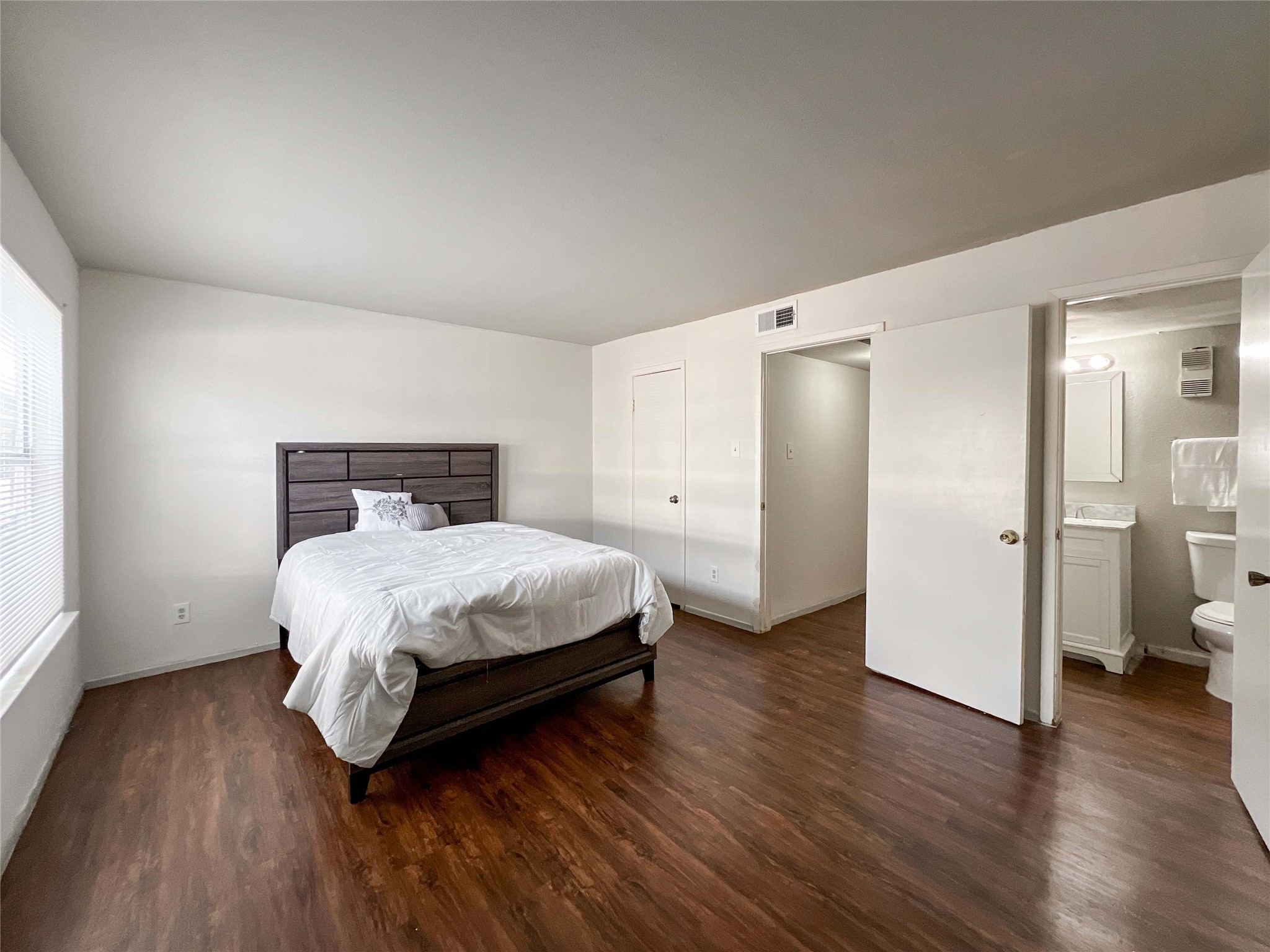 6001 Reims Road, Unit 1207 Houston, TX 77036 - Photo 9 of 18 a bedroom with a bed and wooden floor