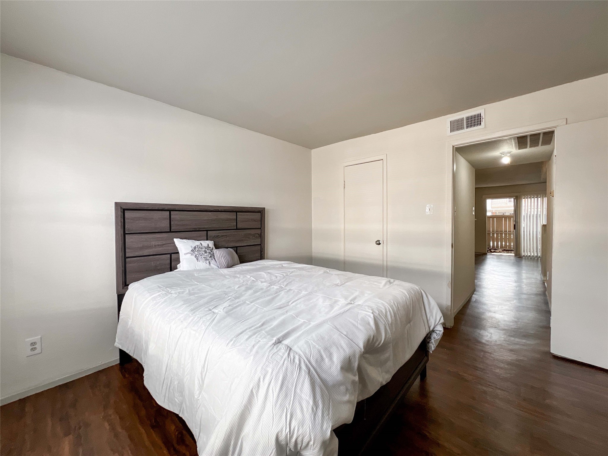 6001 Reims Road, Unit 1207 Houston, TX 77036 - Photo 10 of 18 a bedroom with a bed and wooden floor