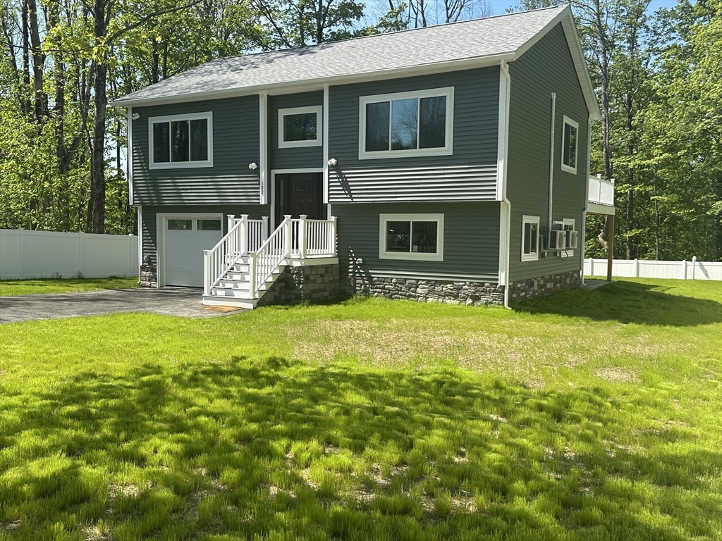 102 Wells Road Becket, MA 01223 - Photo 3 of 40 a front view of a house with garden