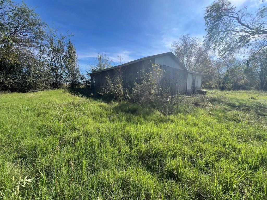 900 North Tbd Farm Road Saltillo, TX 75478 - Photo 4 of 15 a backyard of a house