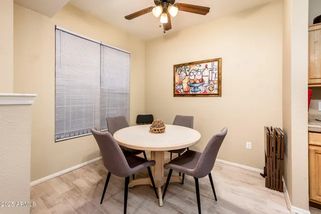 a view of a dining room with furniture and a chandelier