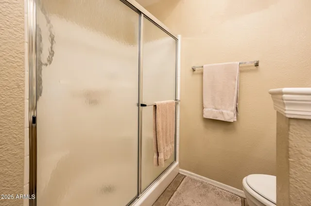 a bathroom with a toilet and a shower