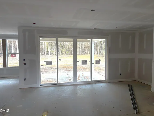 a large kitchen with stainless steel appliances kitchen island a large counter top and a wooden floor