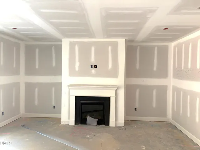 a view of kitchen with stainless steel appliances granite countertop a sink a stove a refrigerator and white cabinets