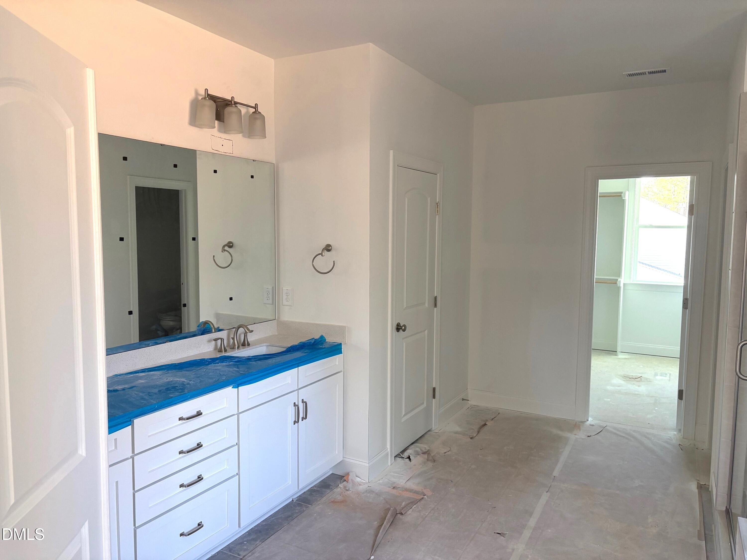 7 East Victoria Ridge Drive, Unit 16 Selma, NC 27576 - Photo 16 of 45 a spacious bathroom with a granite countertop sink mirror and a