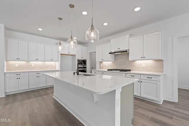 a spacious bathroom with a double vanity sink a mirror and a shower