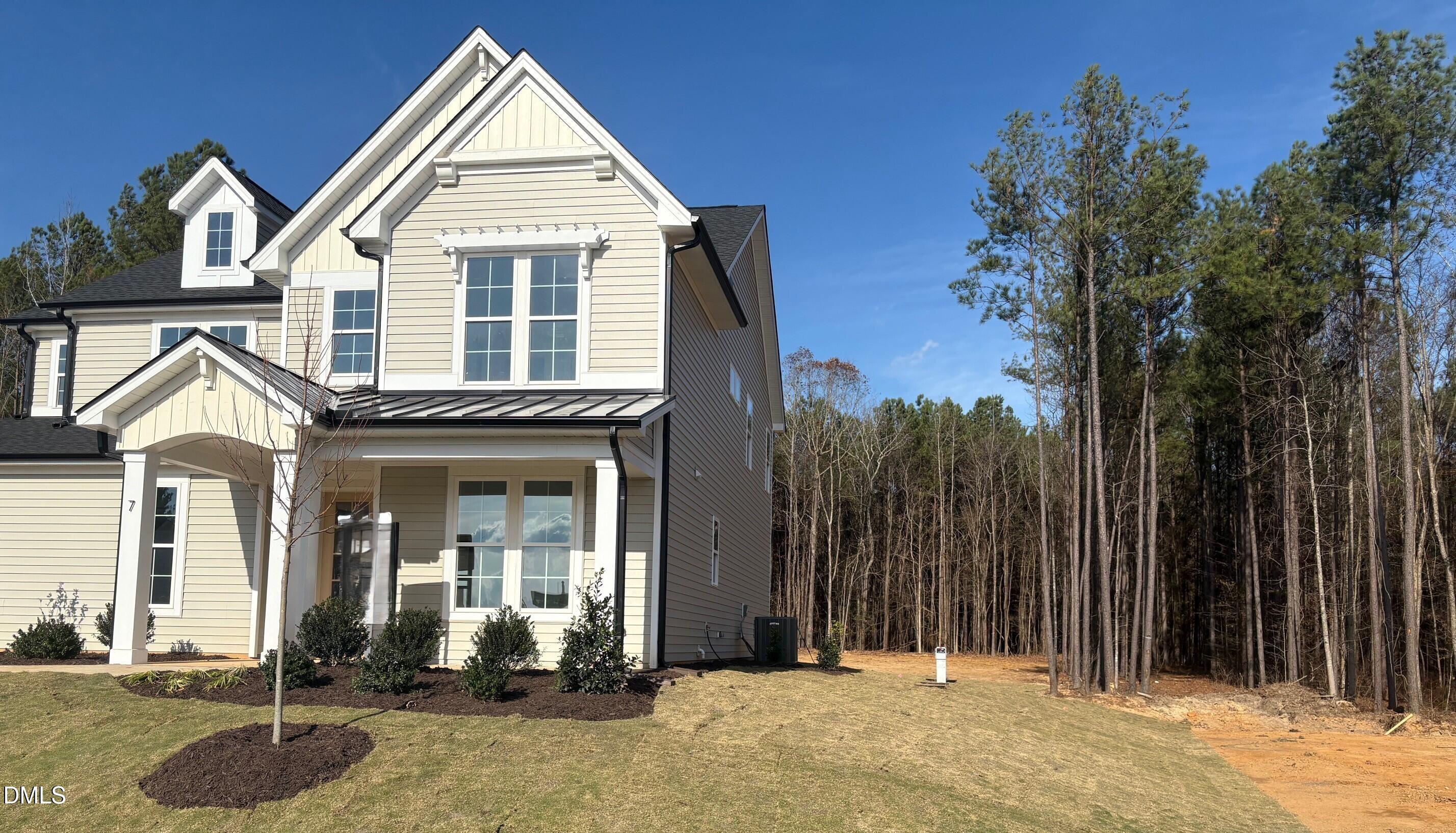 7 East Victoria Ridge Drive, Unit 16 Selma, NC 27576 - Photo 2 of 45 a view of a brick house with large windows and a yard