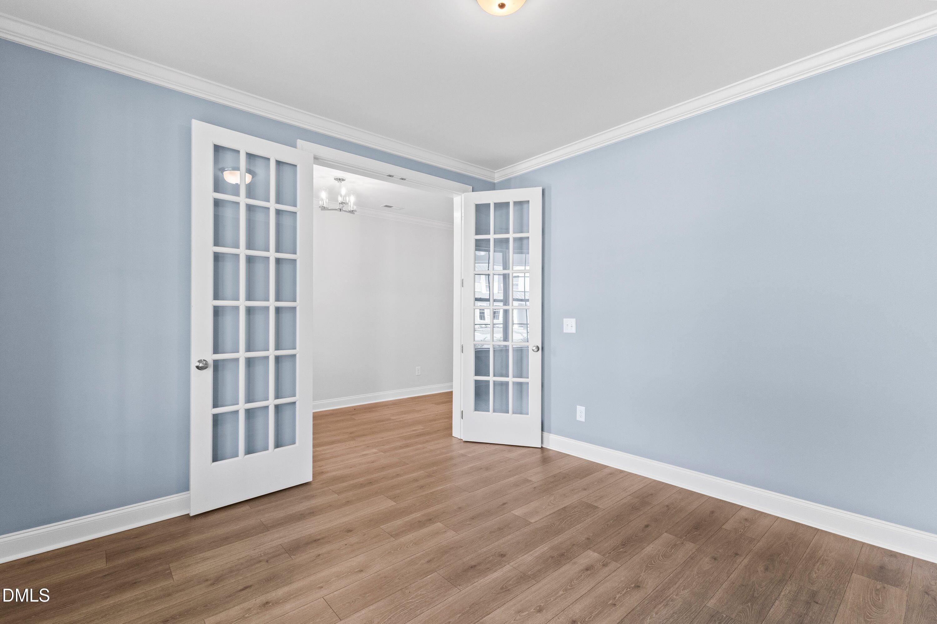 7 East Victoria Ridge Drive, Unit 16 Selma, NC 27576 - Photo 21 of 45 an empty room with wooden floor and windows