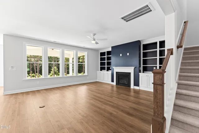 a bathroom with a granite countertop sink toilet a large mirror a shower and a bathtub