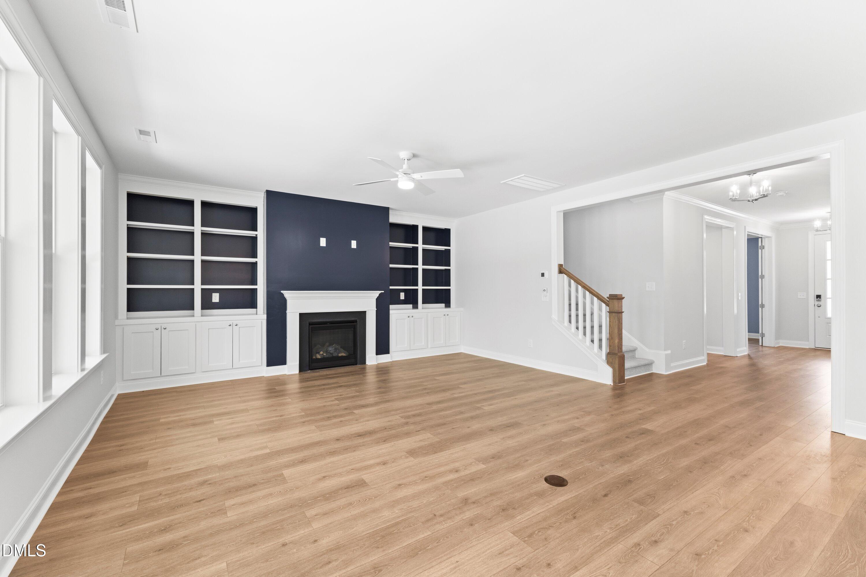 7 East Victoria Ridge Drive, Unit 16 Selma, NC 27576 - Photo 26 of 45 a view of an empty room with wooden floor fireplace and a window