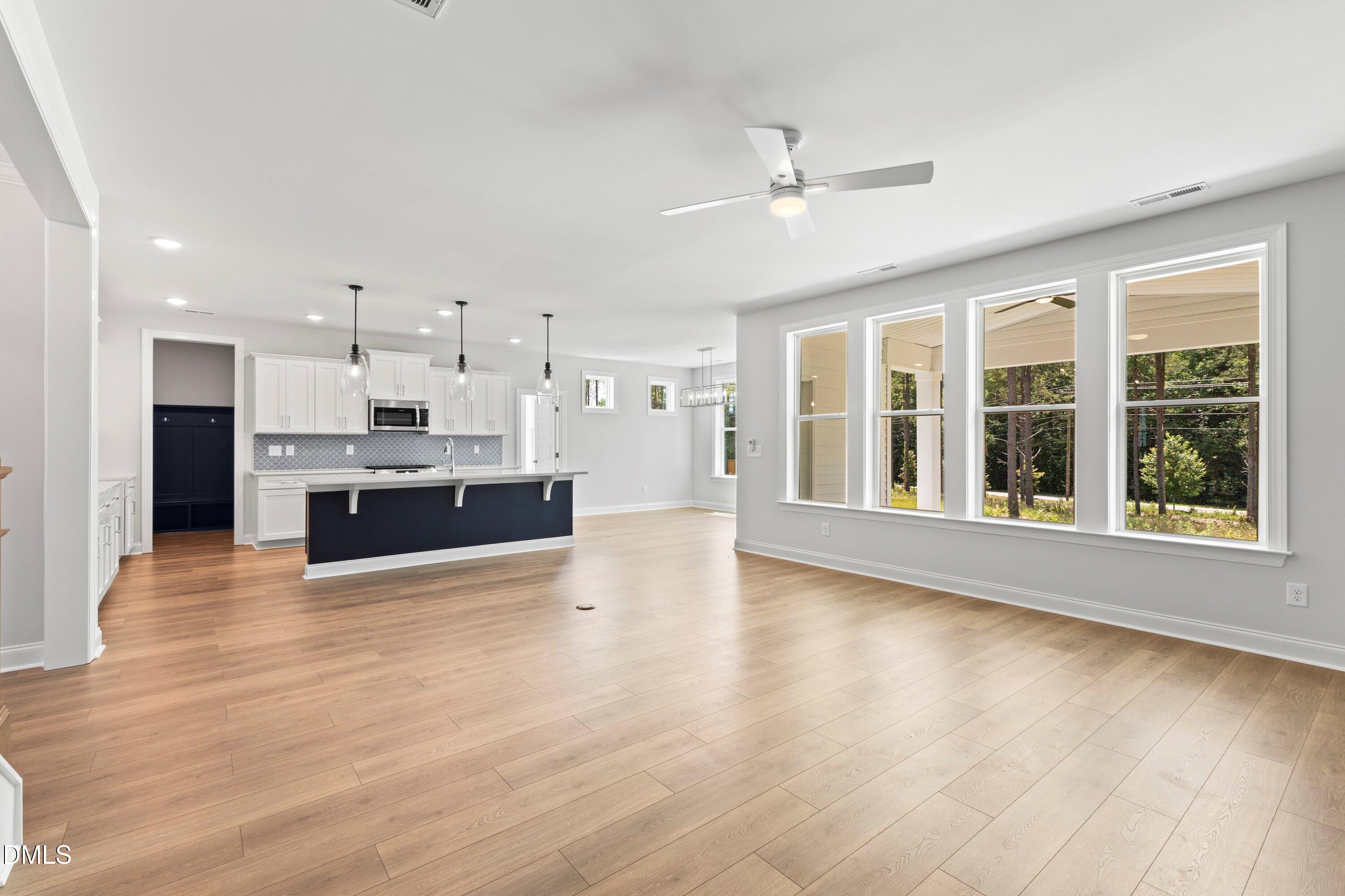 7 East Victoria Ridge Drive, Unit 16 Selma, NC 27576 - Photo 28 of 45 a large kitchen with stainless steel appliances kitchen island a large counter top and a wooden floor