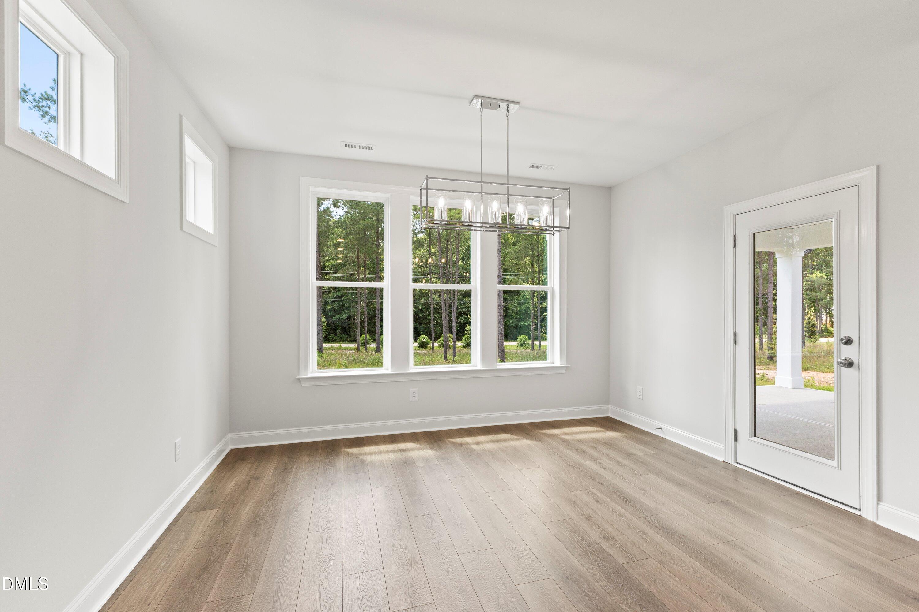 7 East Victoria Ridge Drive, Unit 16 Selma, NC 27576 - Photo 31 of 45 an empty room with wooden floor and windows