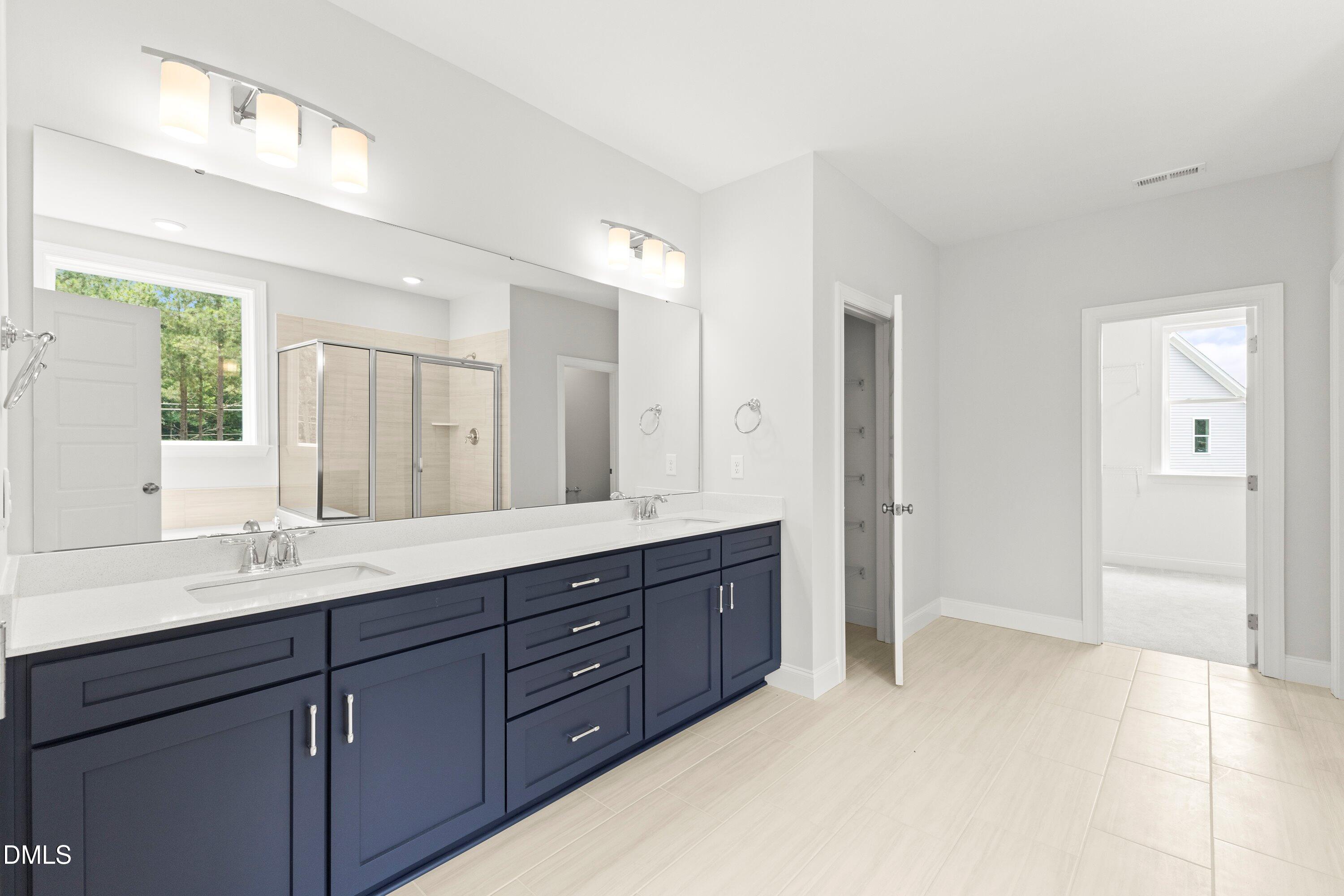 7 East Victoria Ridge Drive, Unit 16 Selma, NC 27576 - Photo 35 of 45 a spacious bathroom with a double vanity sink shower and a mirror