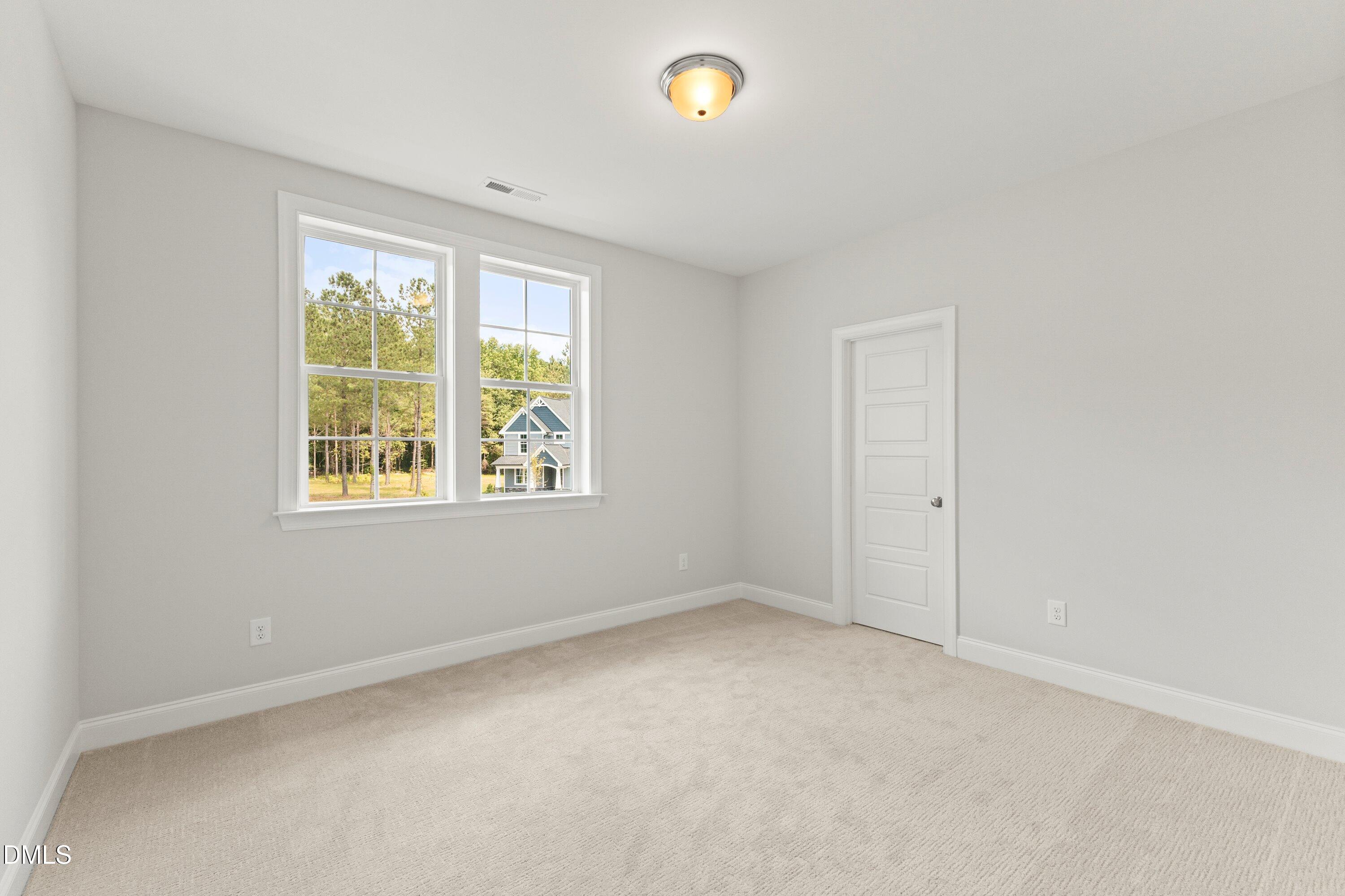7 East Victoria Ridge Drive, Unit 16 Selma, NC 27576 - Photo 40 of 45 an empty room with a window