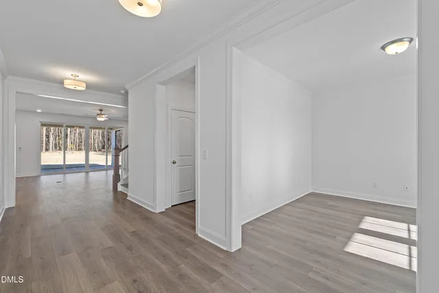 a view of a hallway with wooden floor and entryway