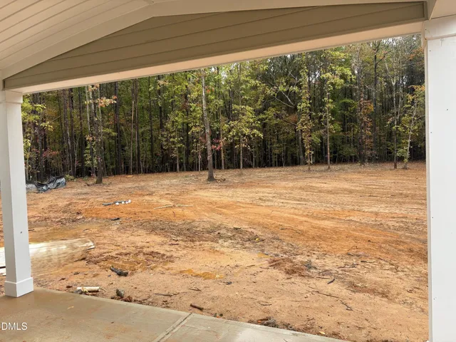 a bathroom with a toilet a sink a mirror and a window