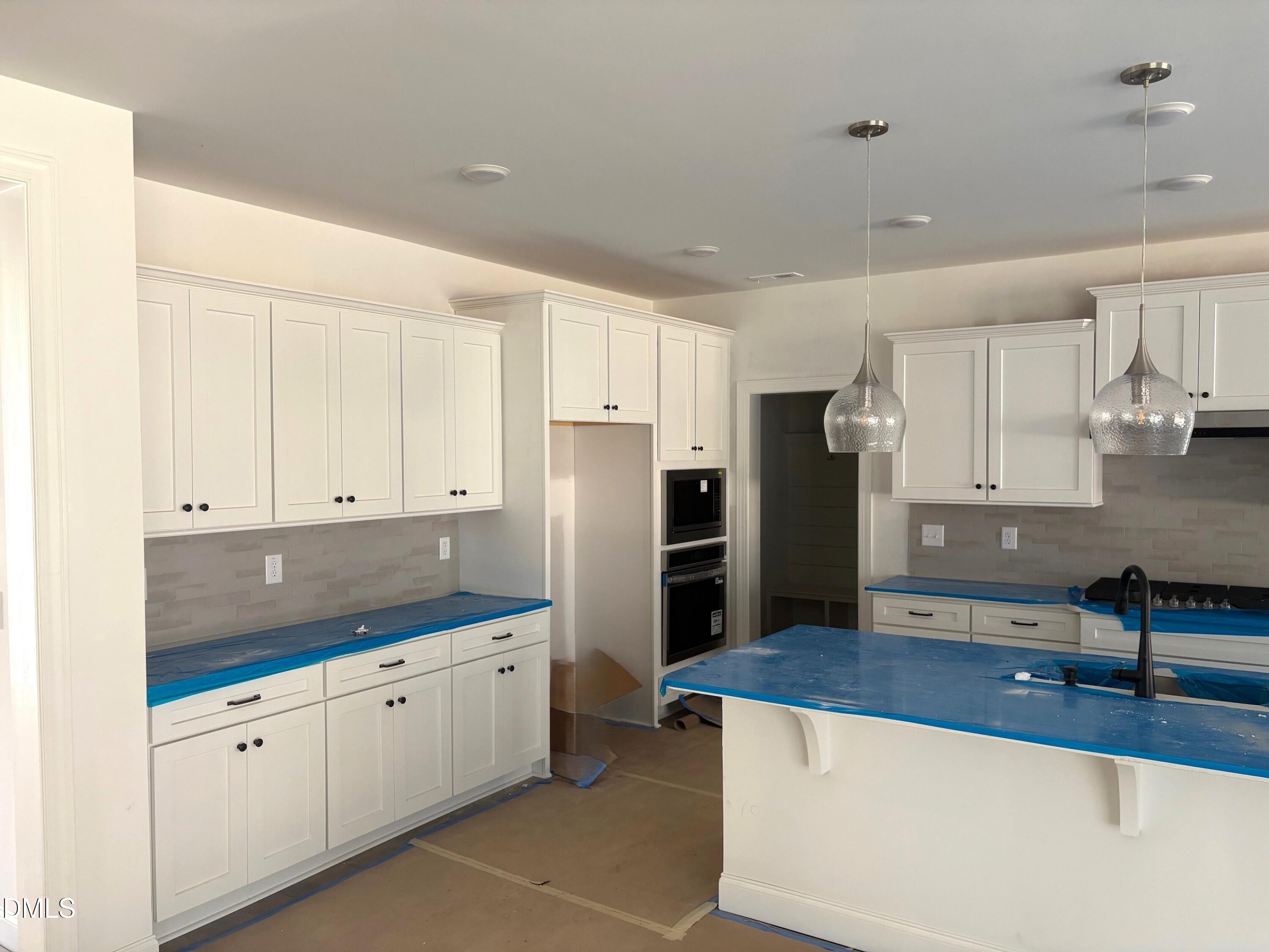 7 East Victoria Ridge Drive, Unit 16 Selma, NC 27576 - Photo 8 of 45 a kitchen with stainless steel appliances granite countertop a refrigerator sink and cabinets