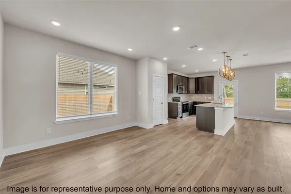 a view of kitchen with granite countertop cabinets stainless steel appliances and a fireplace